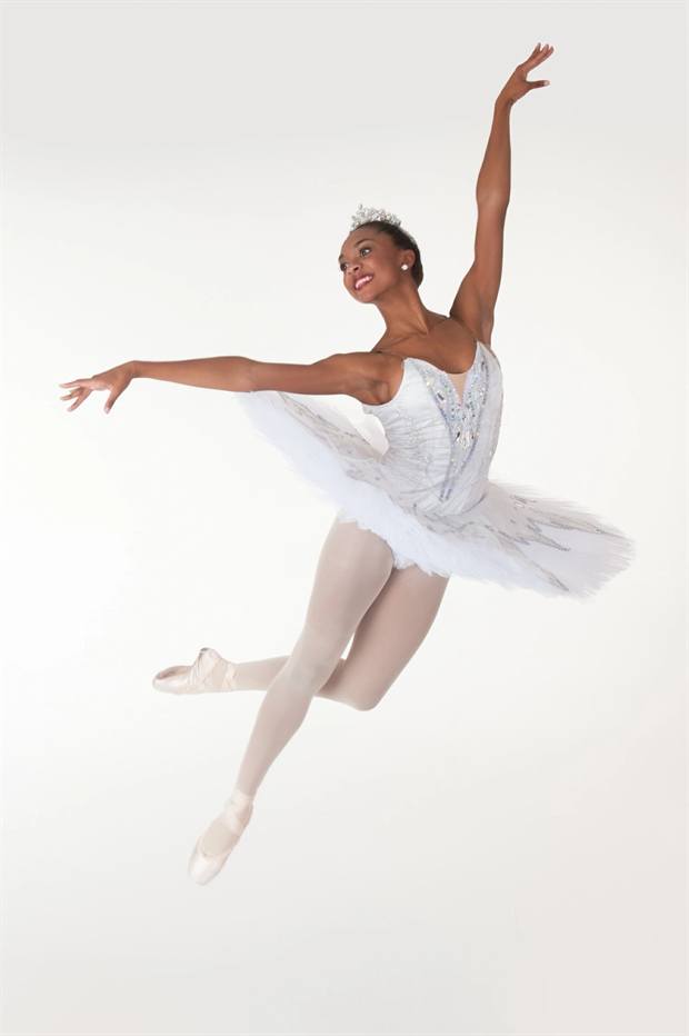 Dancer in a white tutu mid-leap
