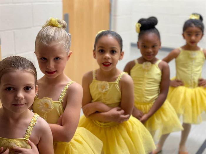 Small children in yellow costumes at the studio