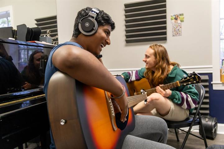 A guitar lesson in progress between instructor and student